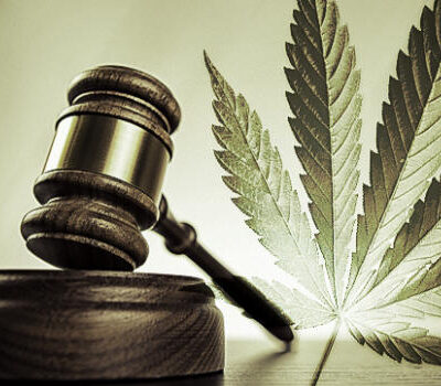 Cannabis leaf beside gavel
