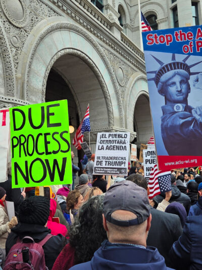 Protest signs reading Stop the Abuse of Power and Due Process Now