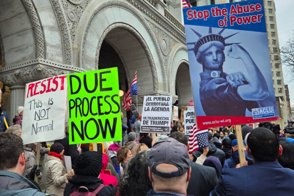 Protest signs reading Stop the Abuse of Power and Due Process Now