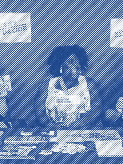 ACLU of Wisconsin staff sitting at a table laden with information and resources