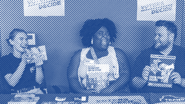 ACLU of Wisconsin staff sitting at a table laden with information and resources