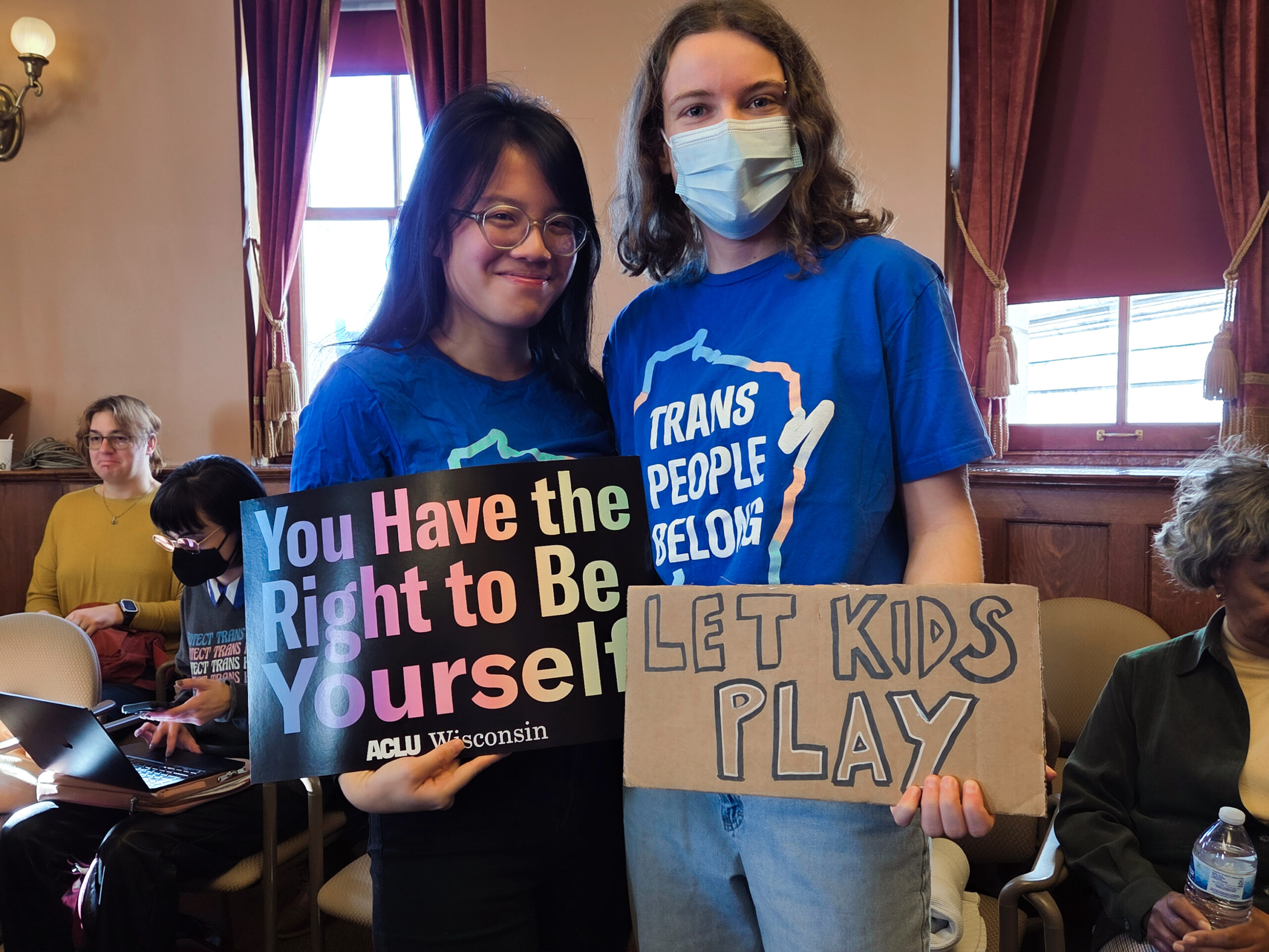 Two people holding signs