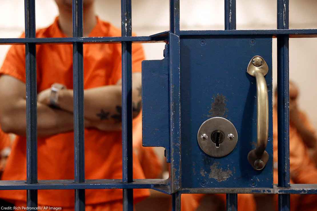 Photo of an inmate behind bars.