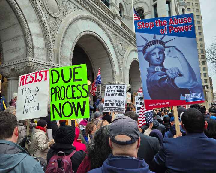 Protest signs reading Stop the Abuse of Power and Due Process Now