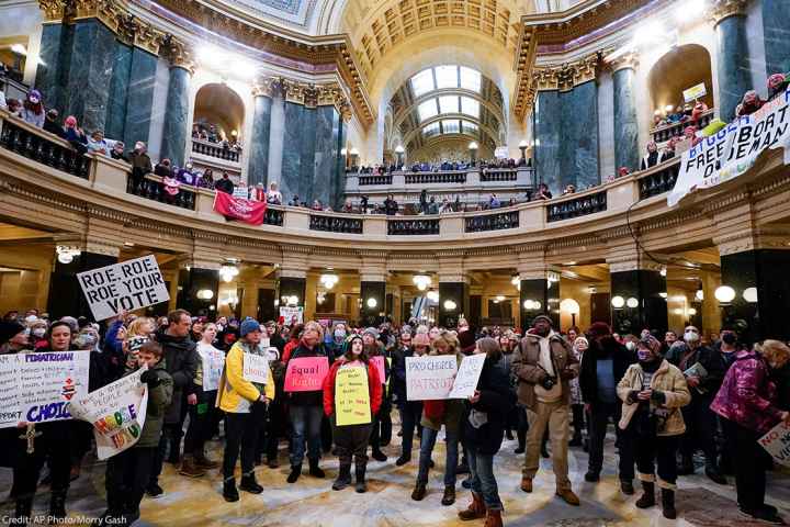 Pro-choice protesters holding signs in the Wisconsin capitol.