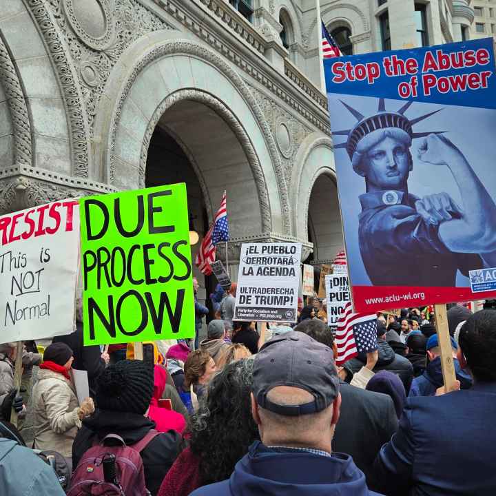 Protest signs reading Stop the Abuse of Power and Due Process Now